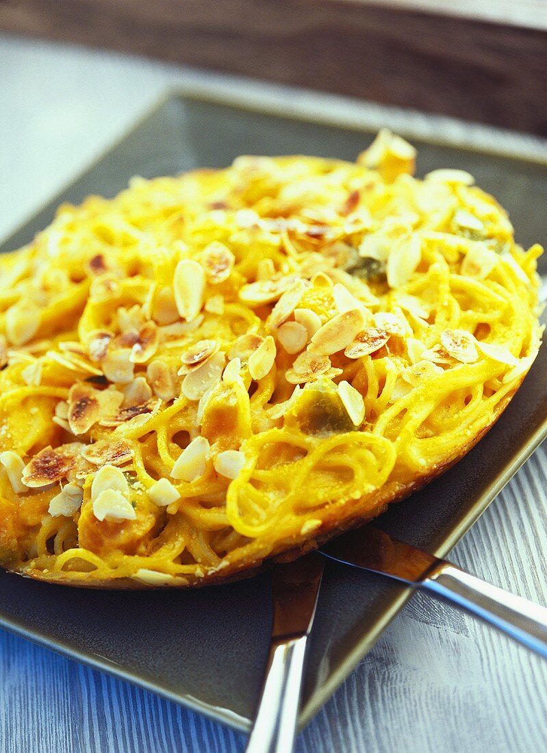 Frittata with pumpkin, spaghetti and flaked almonds