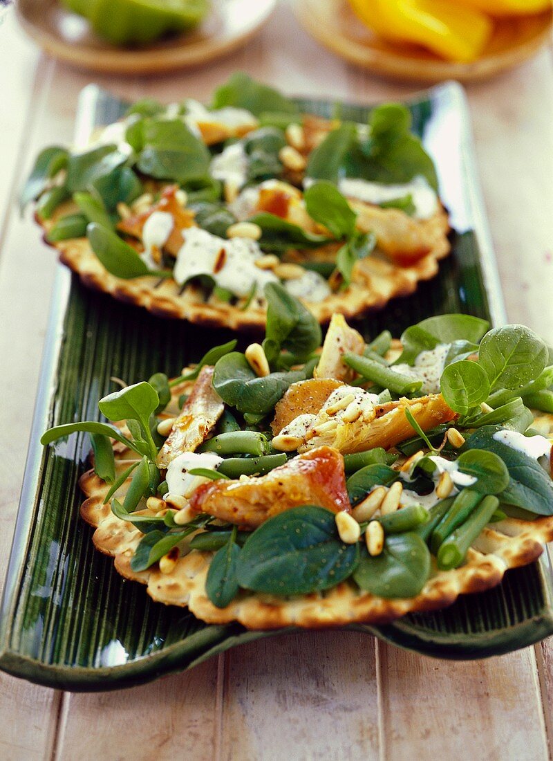Flatbreads with spinach, chicken and pine nuts
