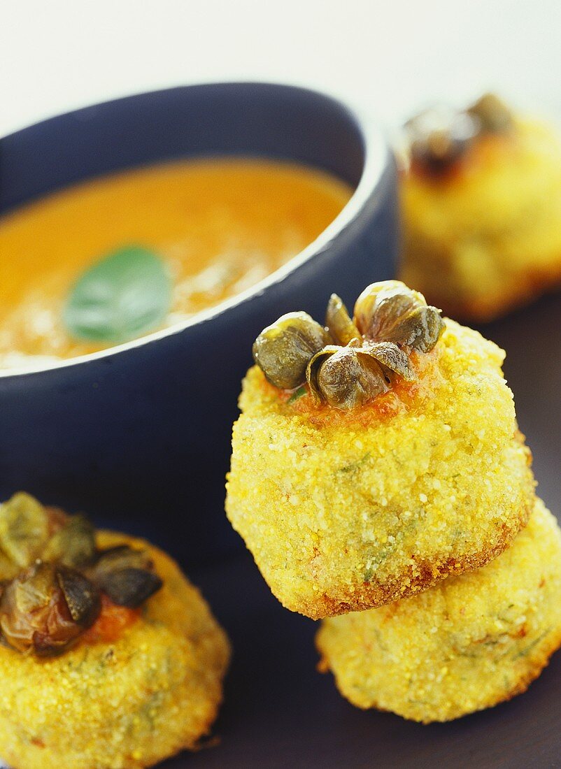 Breaded crab dumplings with capers; pepper sauce