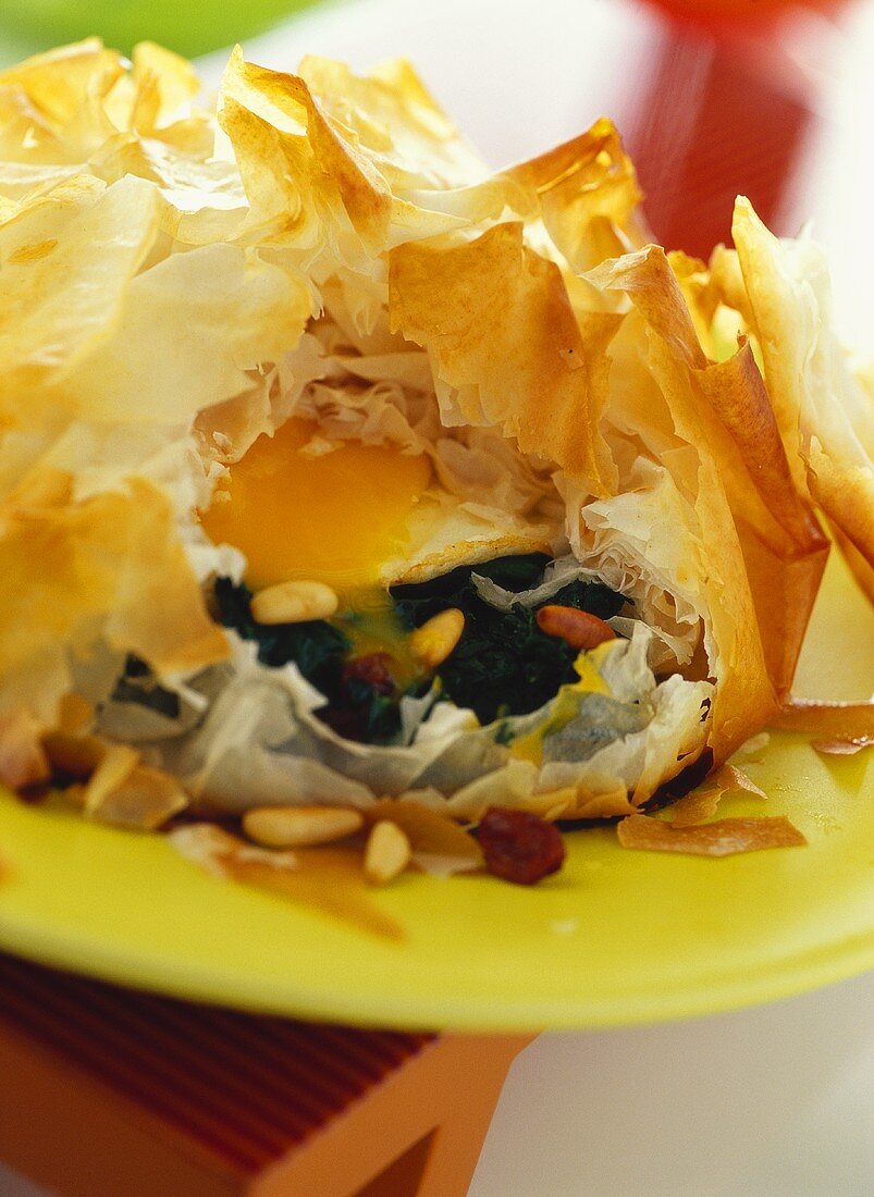 Spinach with egg, raisins and pine nuts in filo pastry