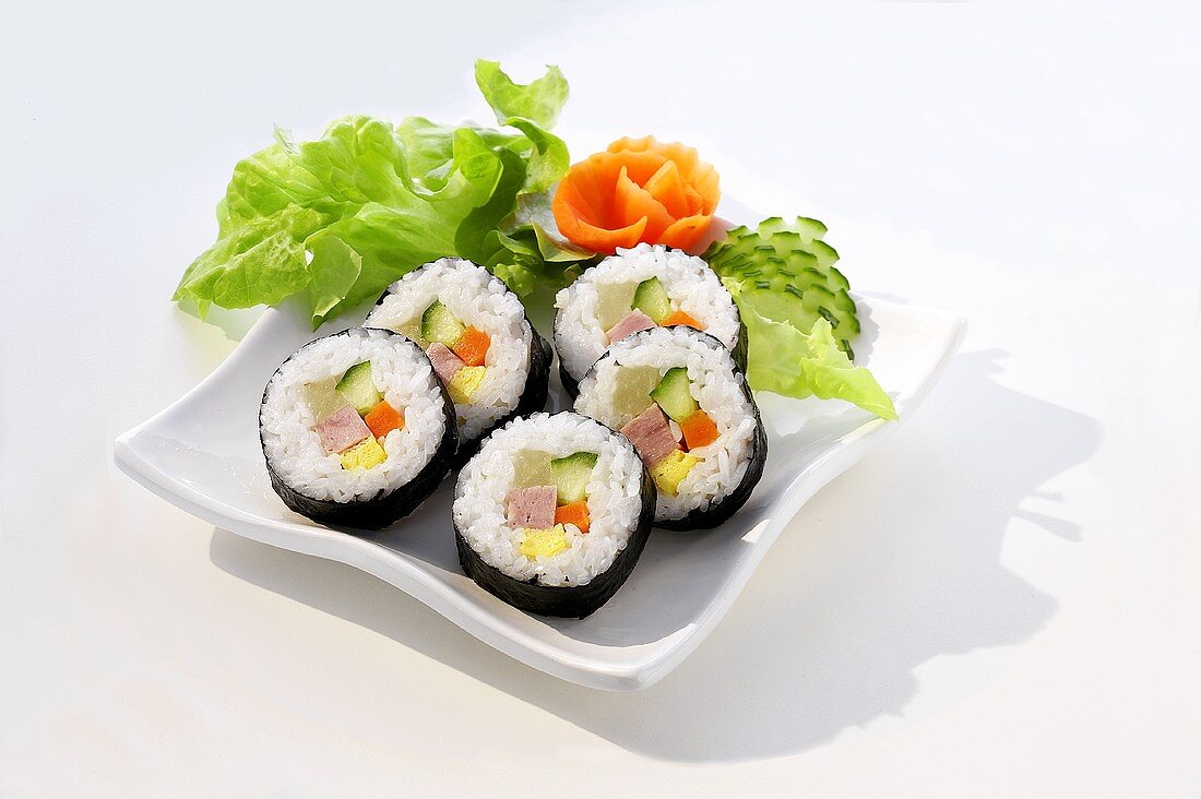 Maki-sushi with ham, garnished with vegetables