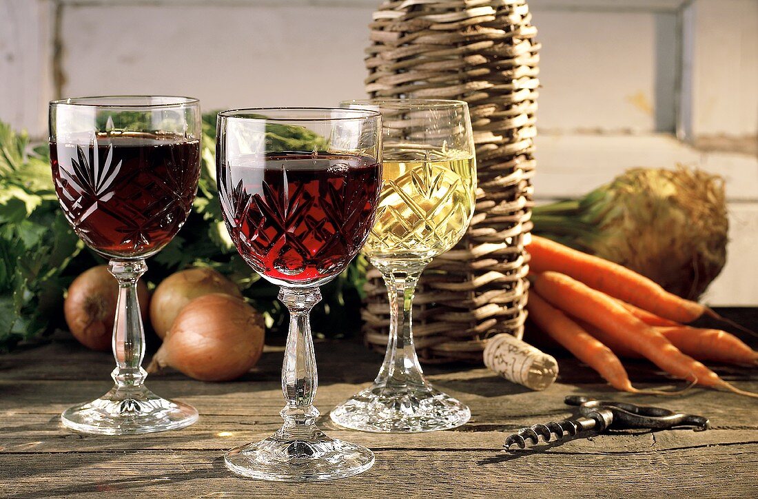 Still life: red wine glasses, white wine glass, soup vegetables