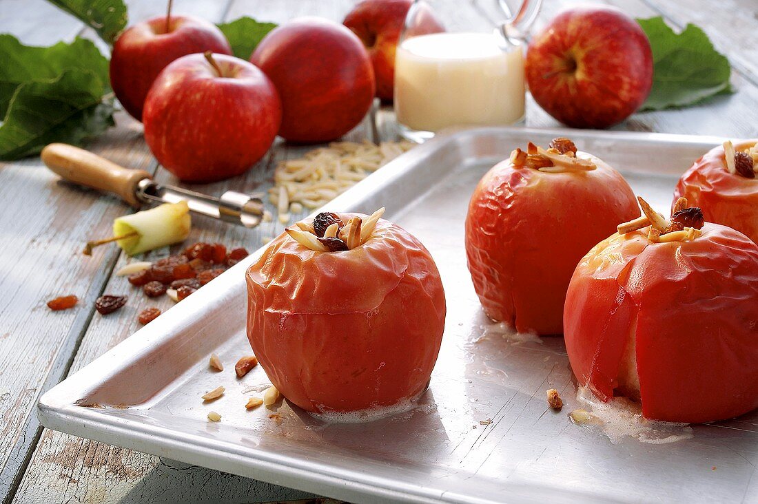 Baked apples with raisins and almonds on baking tray