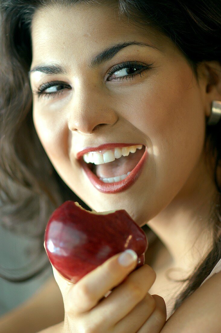 Junge Frau isst roten Apfel