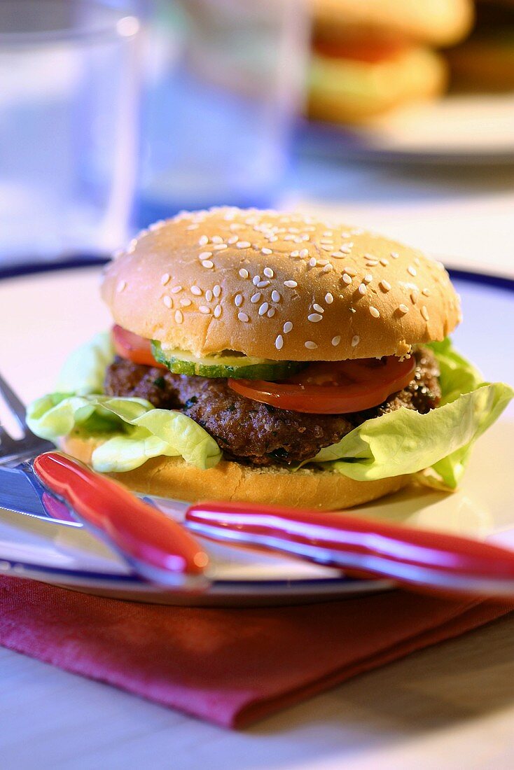 Hamburger on plate with cutlery