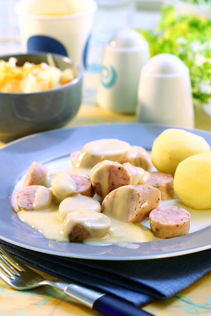 Brühwurst (scalded sausage) in beer sauce with boiled potatoes