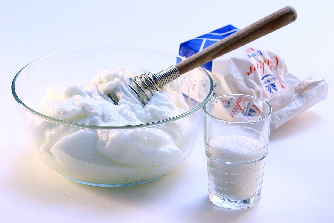 Mixing beaten egg white with sugar