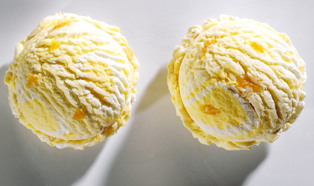 Two scoops of peach and yoghurt ice cream