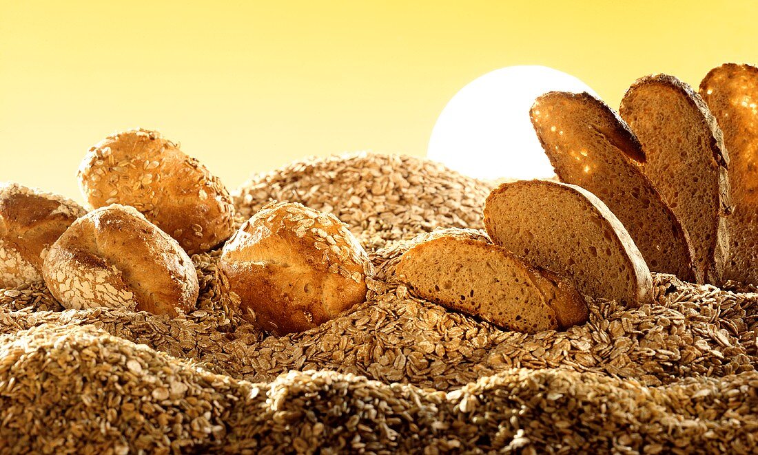 Bread and rolls on mountain of oats