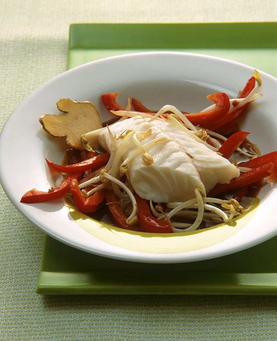 Fish fillet with ginger on peppers and sprouts