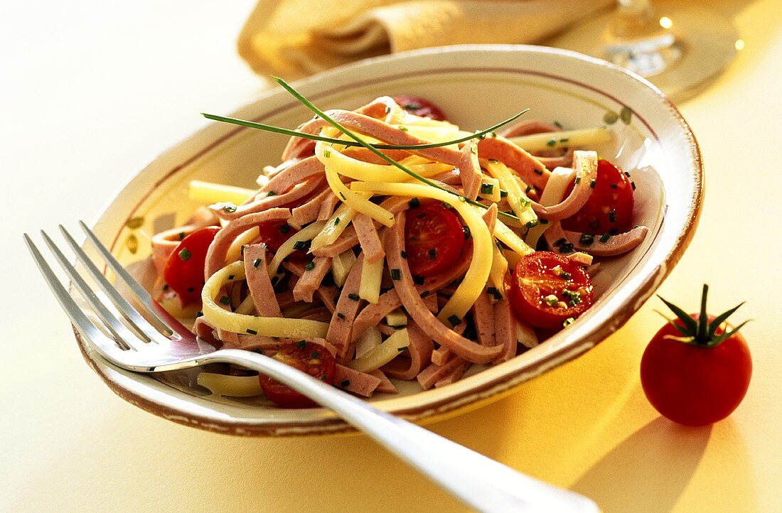 Sausage salad with cheese and tomatoes