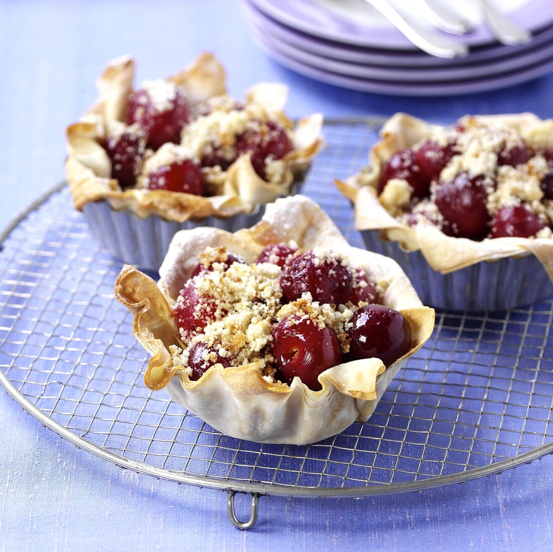 Cherry tarts on cake rack