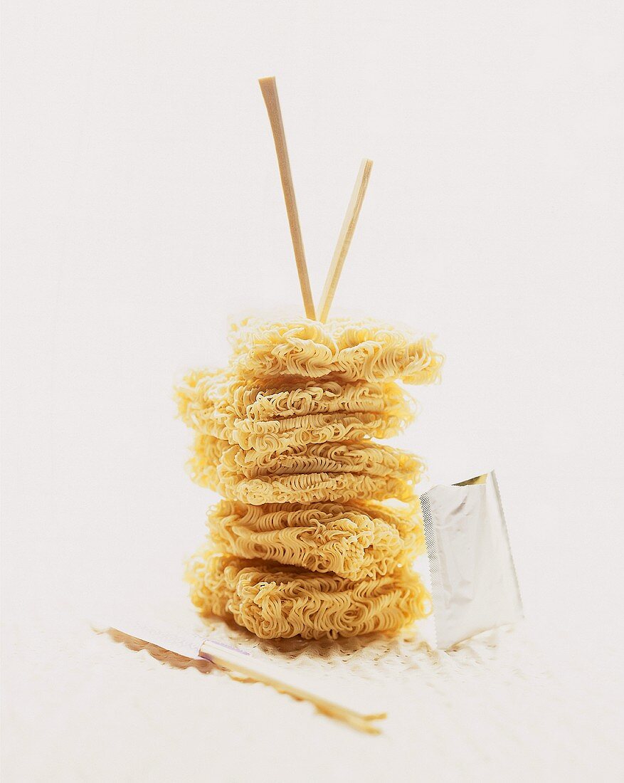 Asian egg noodles, in a pile, with wooden chopsticks