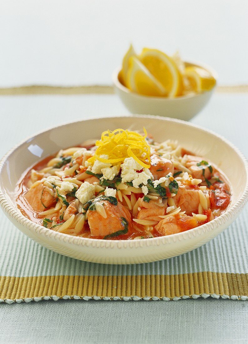 Stew of salmon, pasta, tomatoes and sheep's cheese