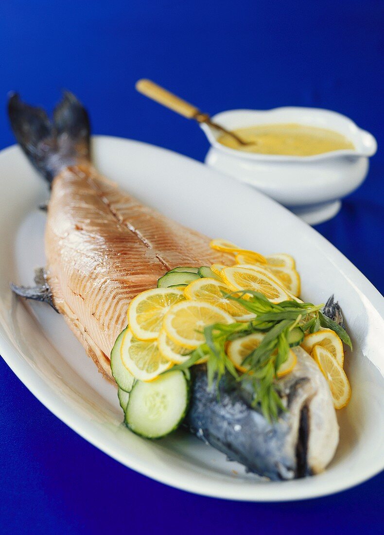 Poached salmon with slices of lemon and cucumber