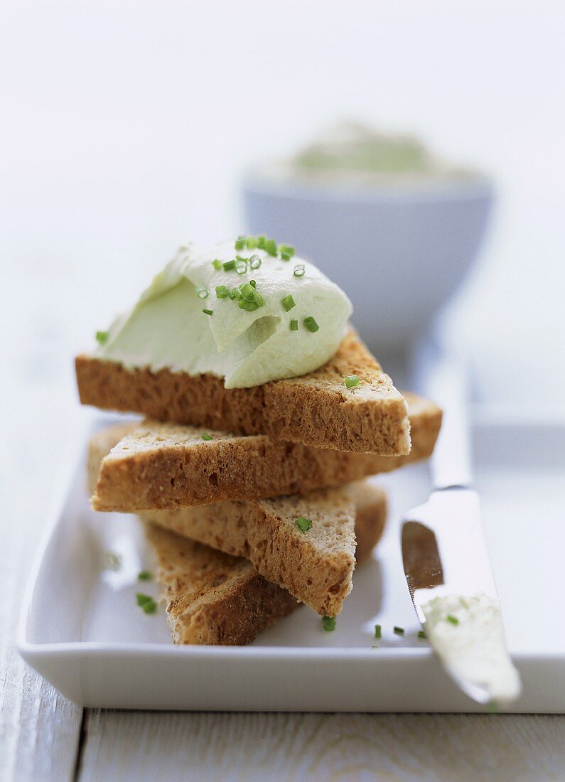 Wholemeal toast with soft cheese and avocado spread