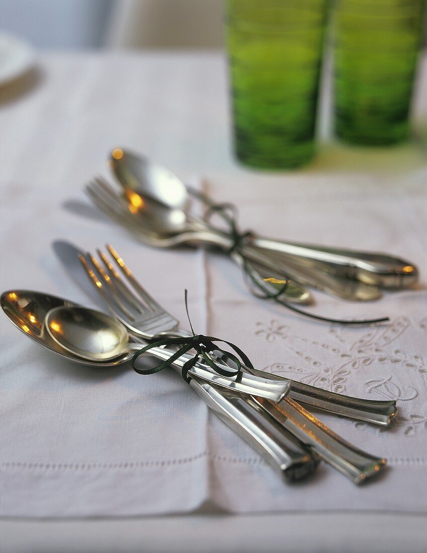 Cutlery tied together with green ribbon