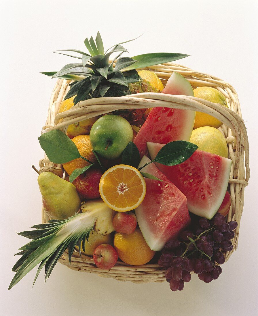 Basket of fruit, whole and cut into