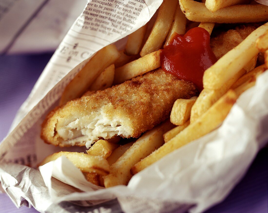 Fish and Chips with Ketchup Rolled in Newspaper