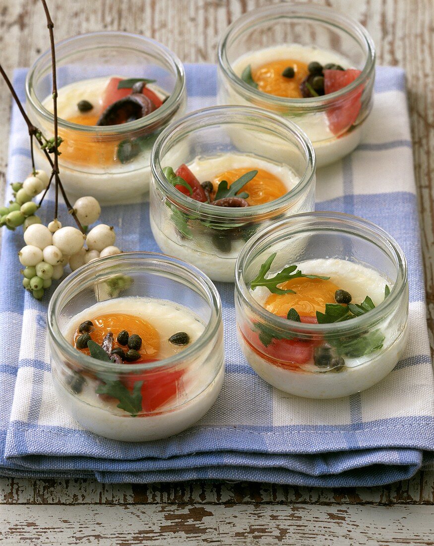 Poached eggs with capers, anchovies & tomatoes in moulds