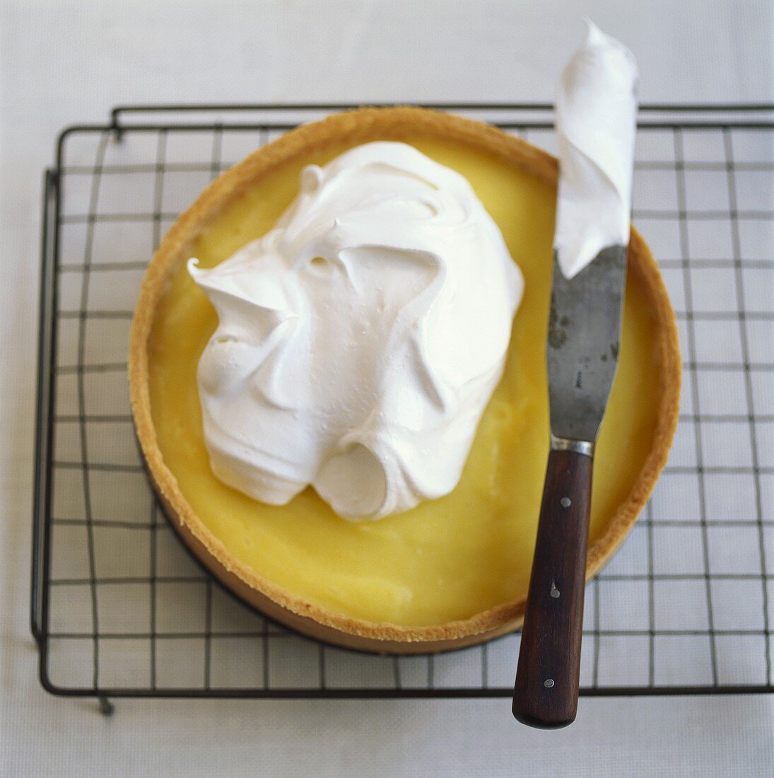 Spreading vanilla tart with whipped cream