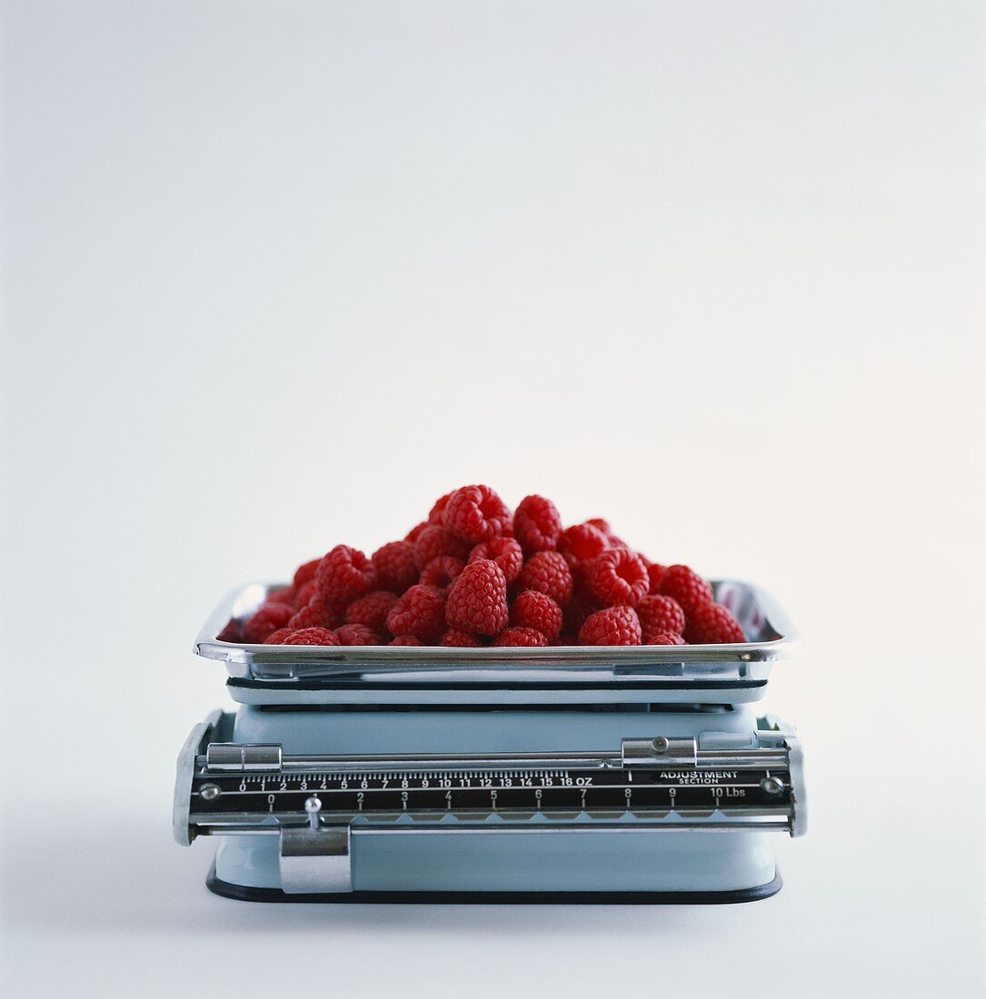 Fresh raspberries on kitchen scales