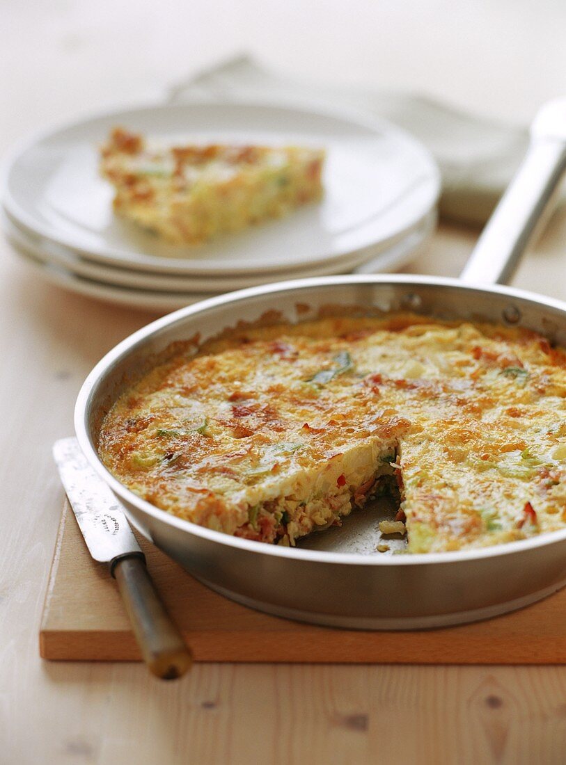 Frittata with ham and sheep's cheese in frying pan