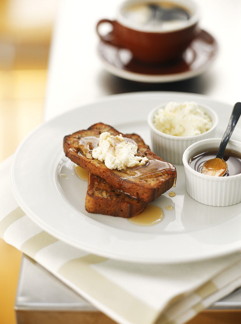Pecan bread with maple syrup and soft cheese for breakfast