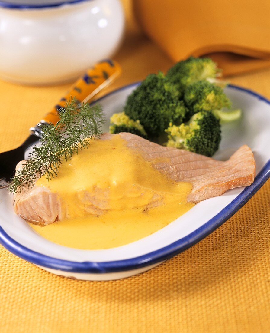 Poached salmon with saffron sauce and broccoli