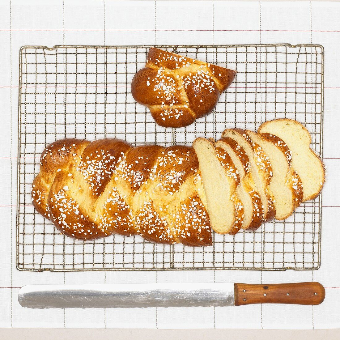 Bread plait with sugar, slices cut, on cake rack