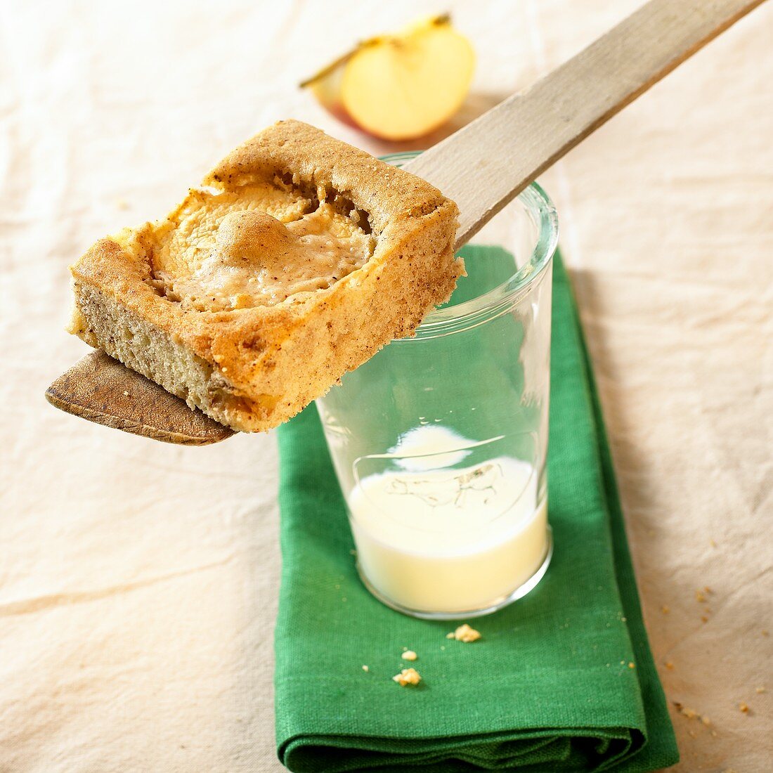 A piece of quick apple cake on a glass of milk