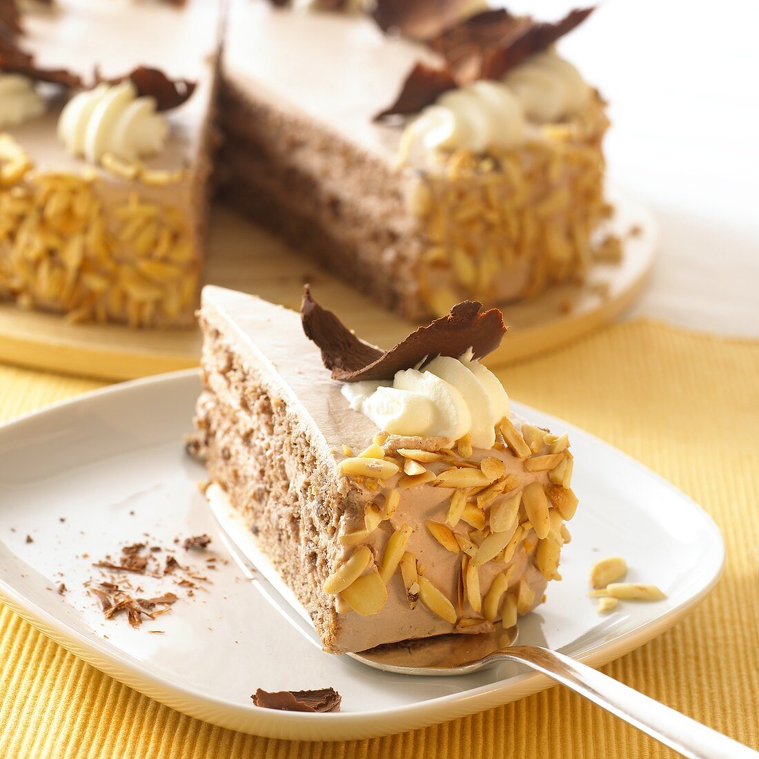 Whiskey and cream gateau with almonds and chocolate curls