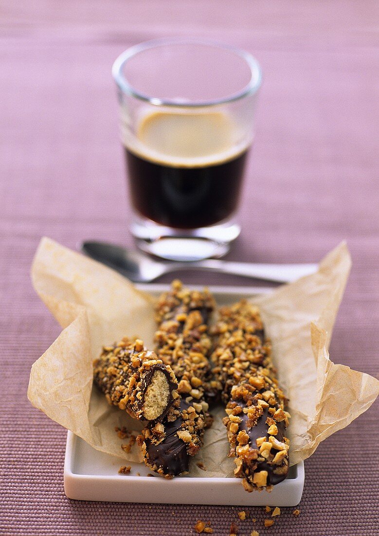 Walnut sticks with chocolate icing; coffee