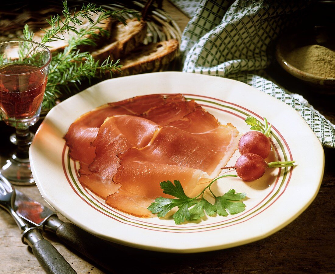 Westphalian ham with radishes on plate
