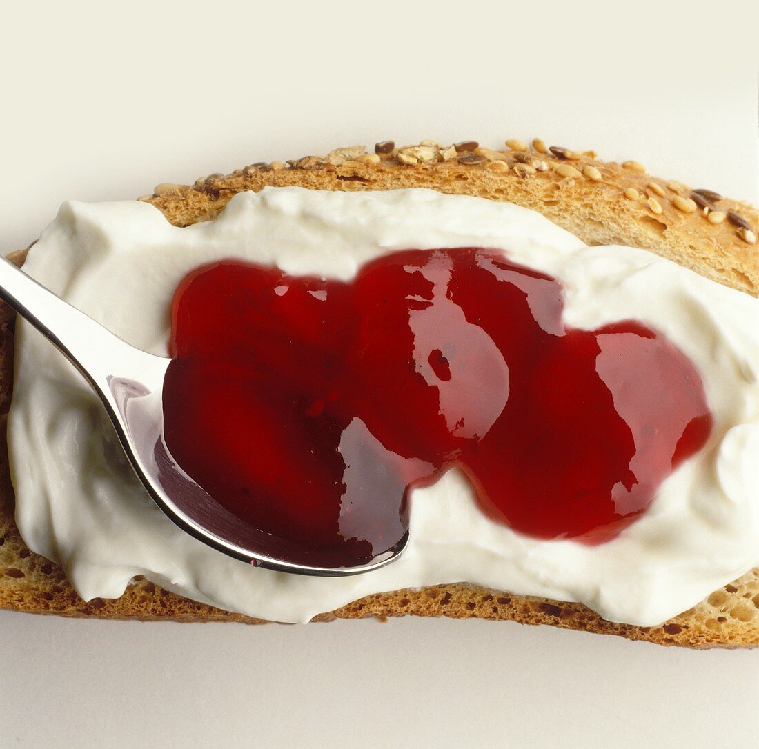 Wholemeal bread spread with quark and berry jam