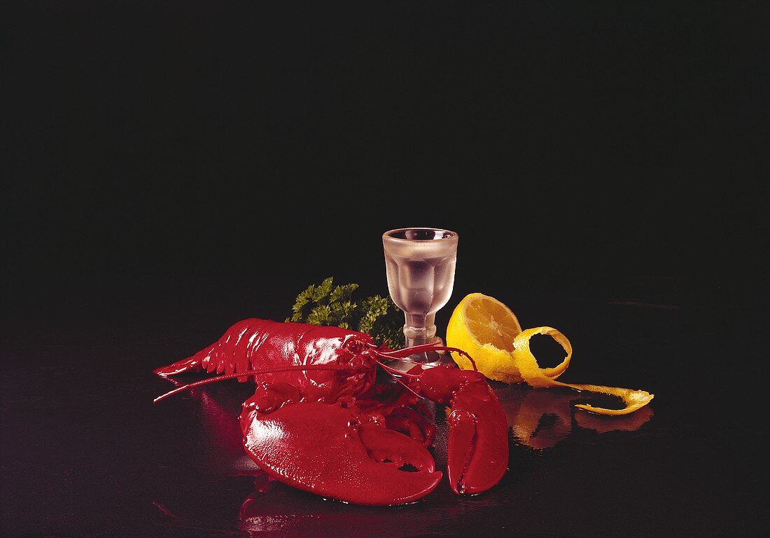 Cooked lobster with lemon on black background