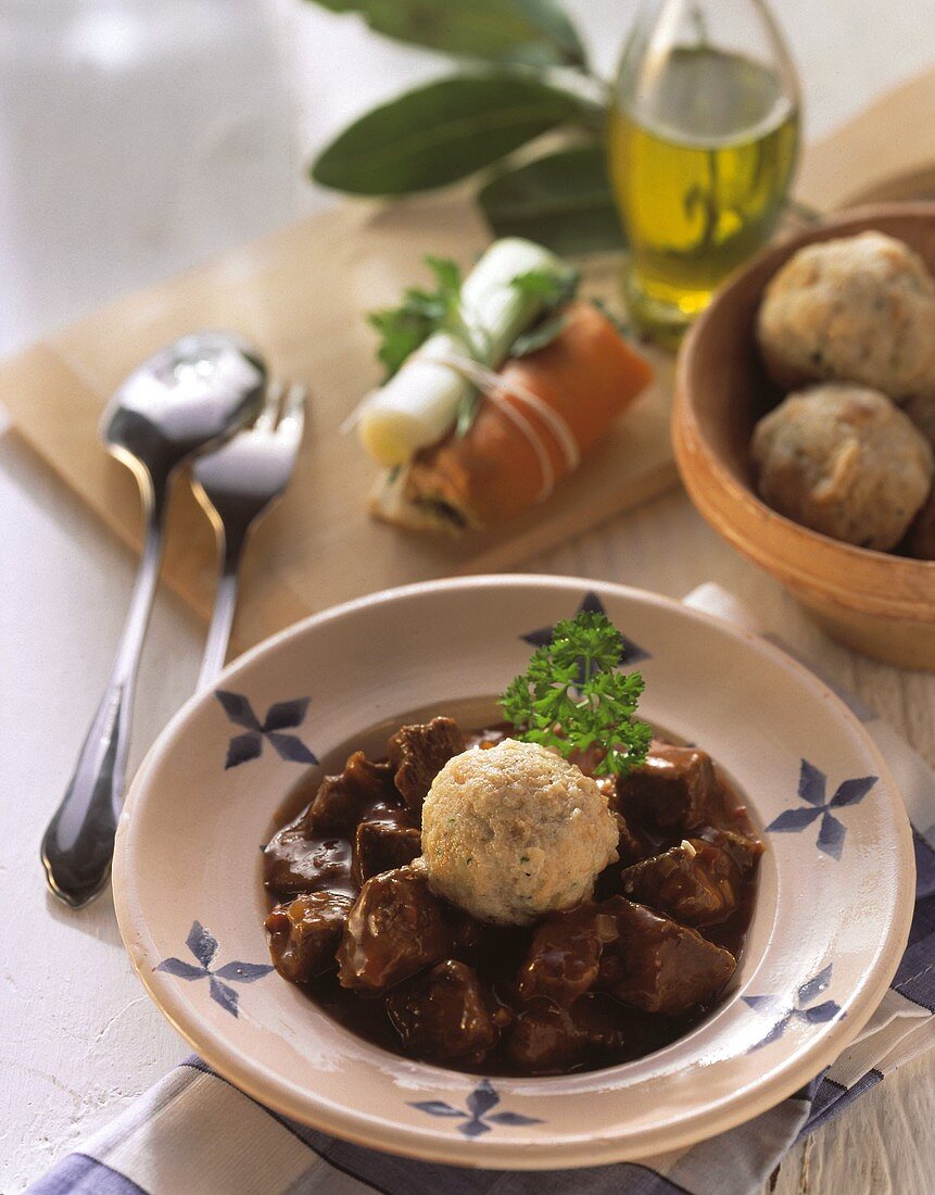 A plate of goulash with bread dumplings