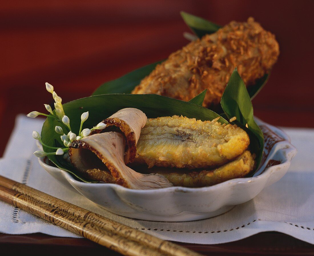 Baked bananas with duck on banana leaf