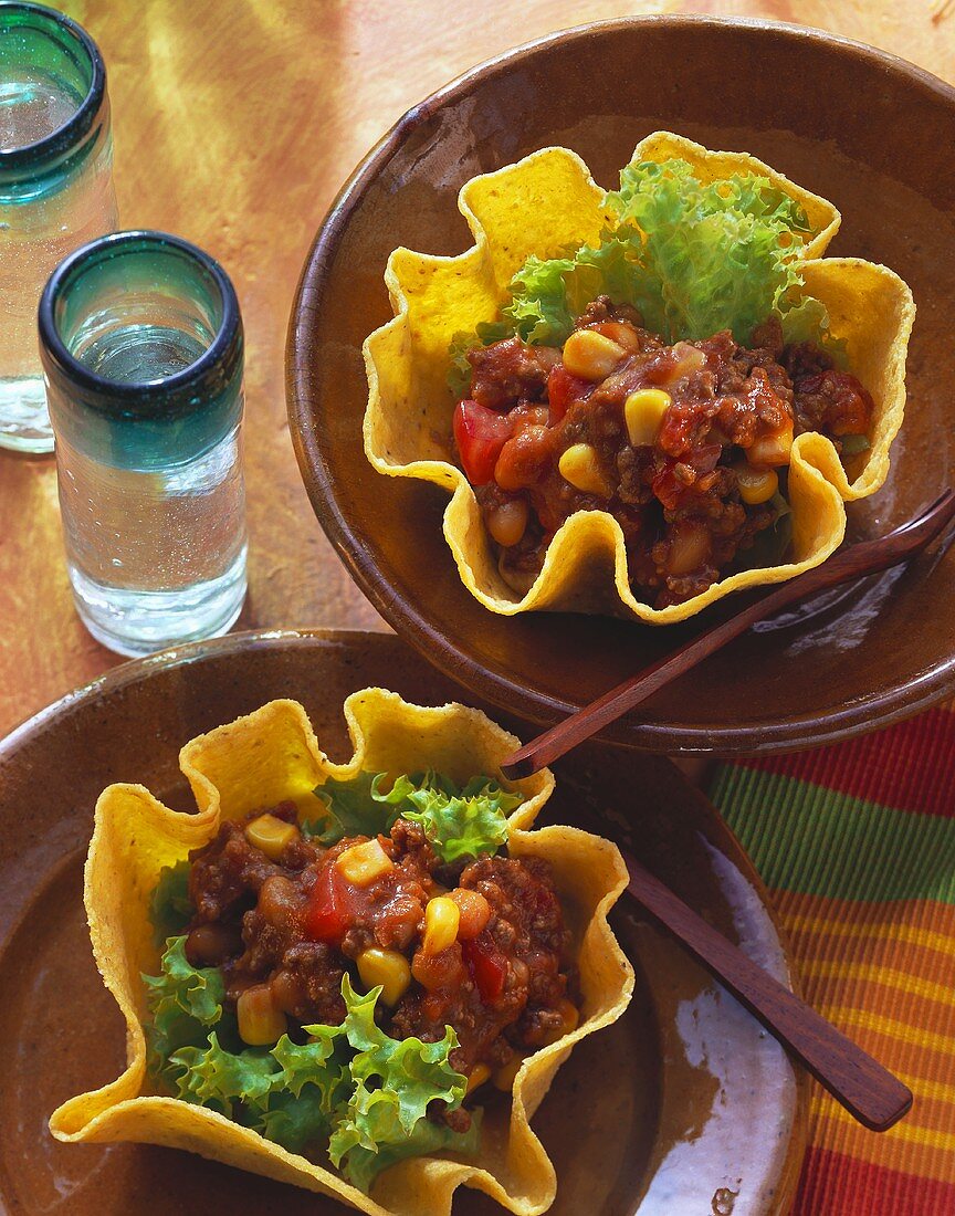 Zwei Taco-Schälchen mit Tomaten-Bohnen-Füllung