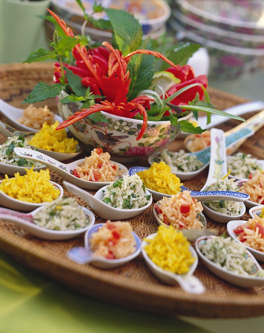 Colourful rice salads on Asian spoons