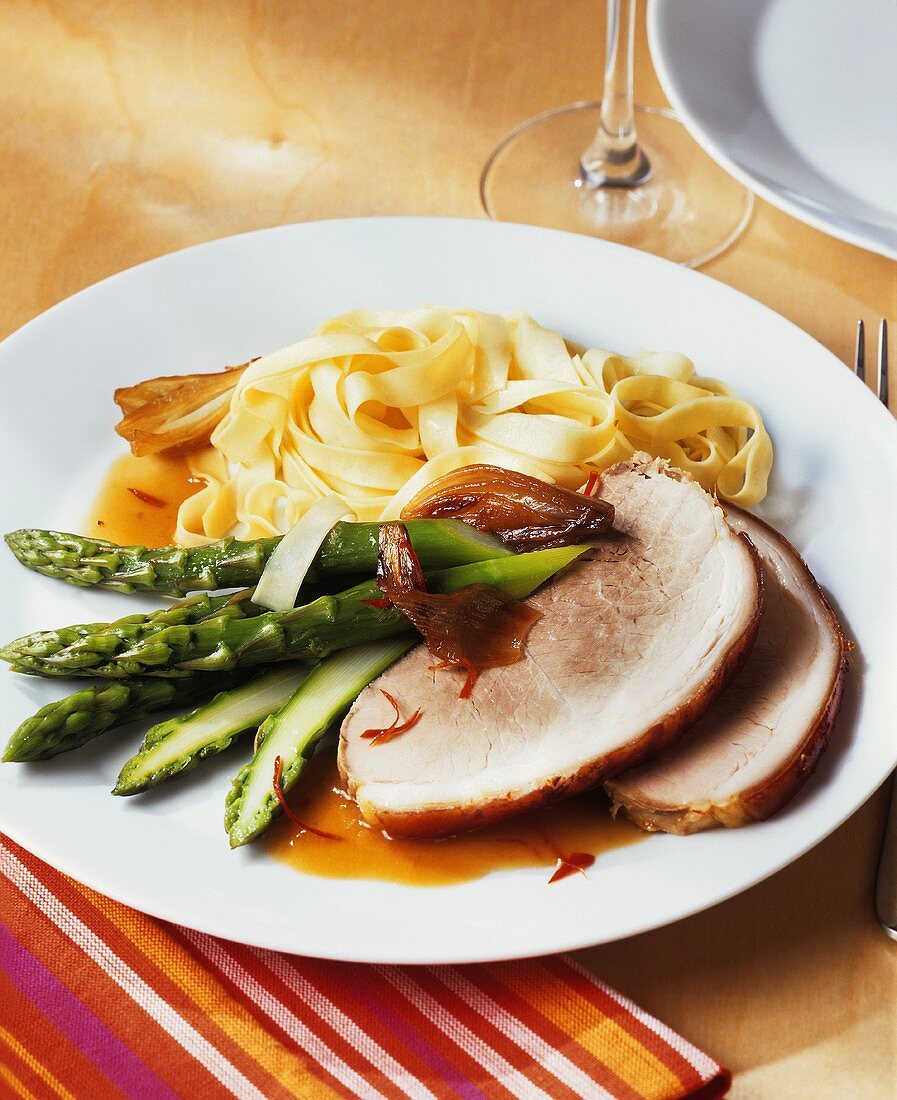 Roast pork roll with green asparagus and ribbon noodles