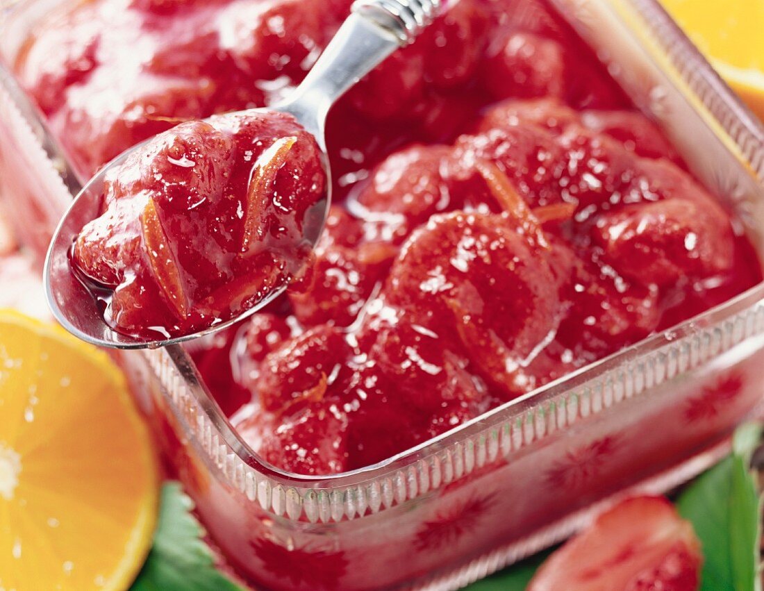 Strawberry and orange jam in glass bowl