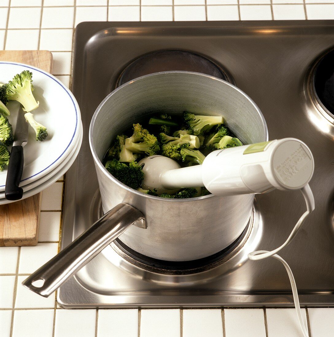 Chopping cooked broccoli florets with hand blender