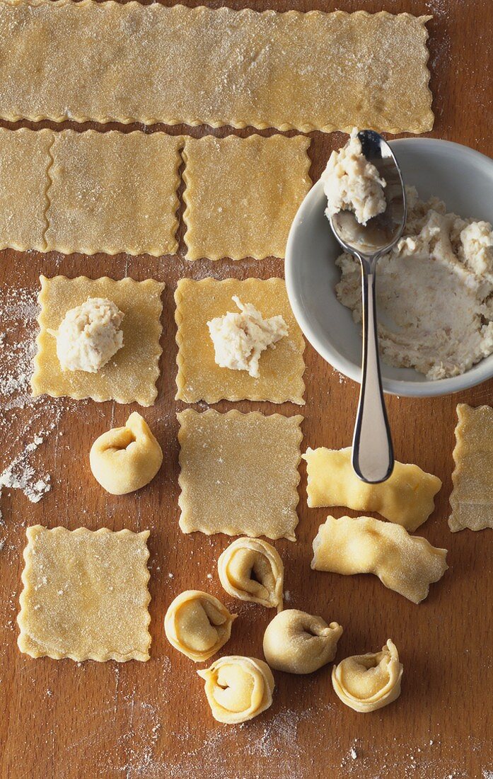 Making tortellini with ricotta and meat filling