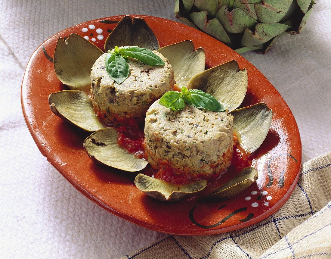 Two artichoke pates on tomato sauce