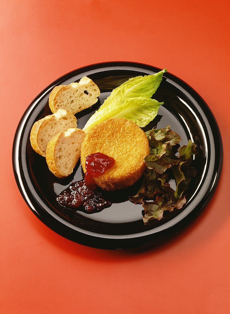 Fried Camembert with cranberry jam on plate