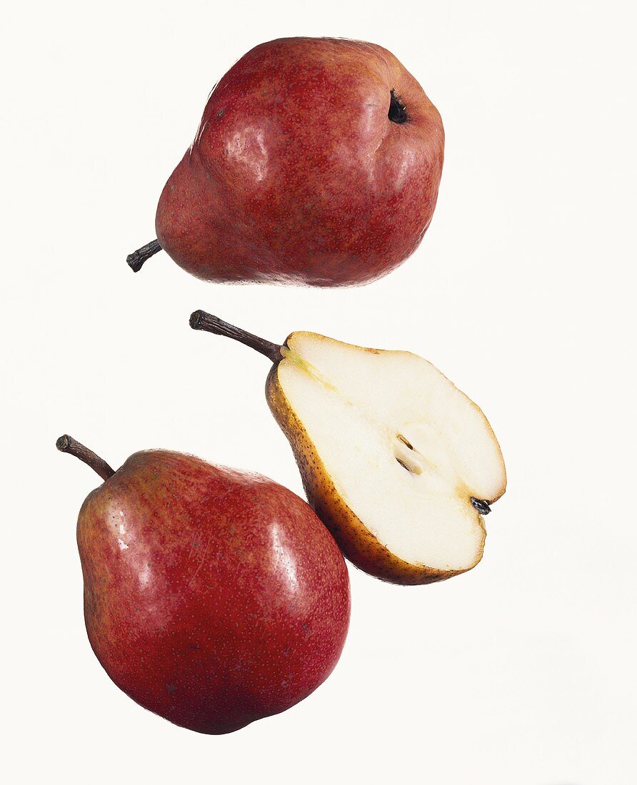 Two whole Williams pears and half a pear