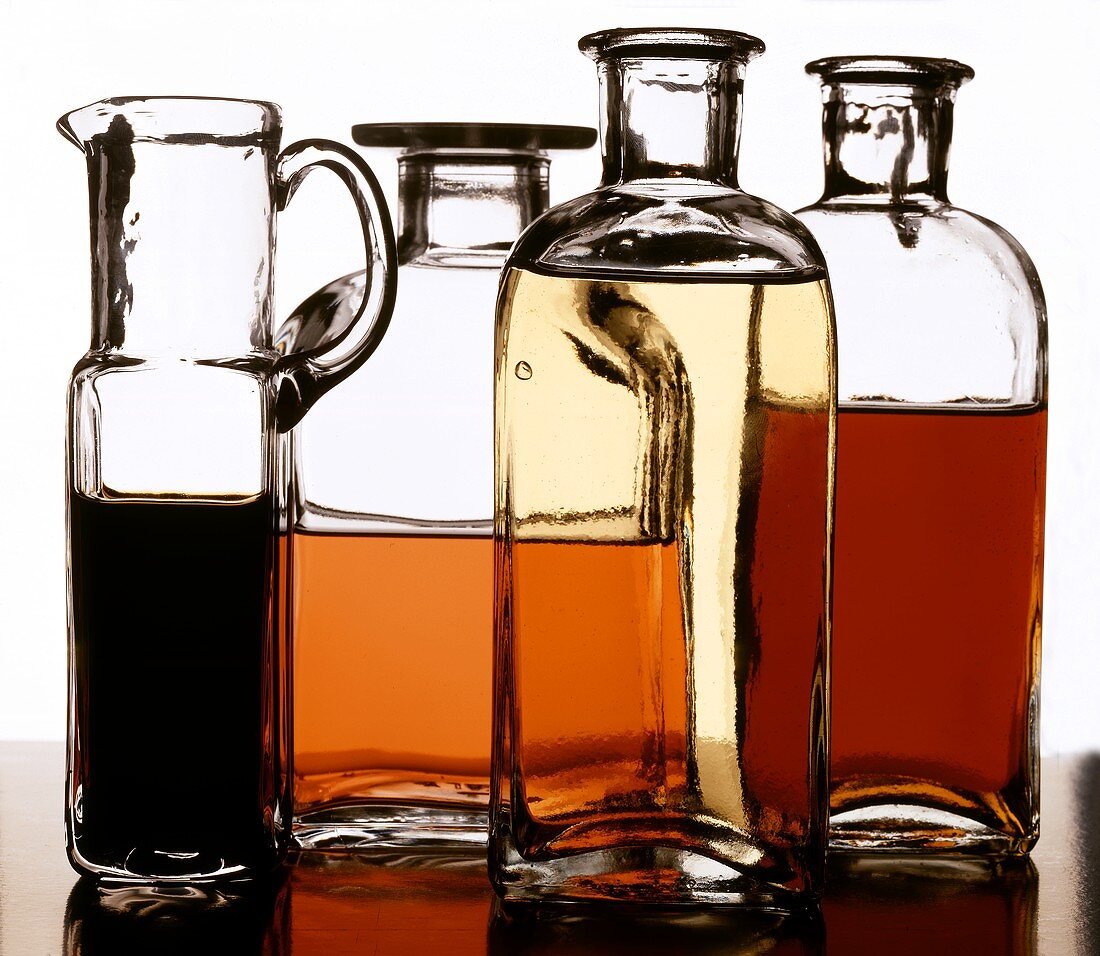 Types of vinegar and oil in bottles and carafe