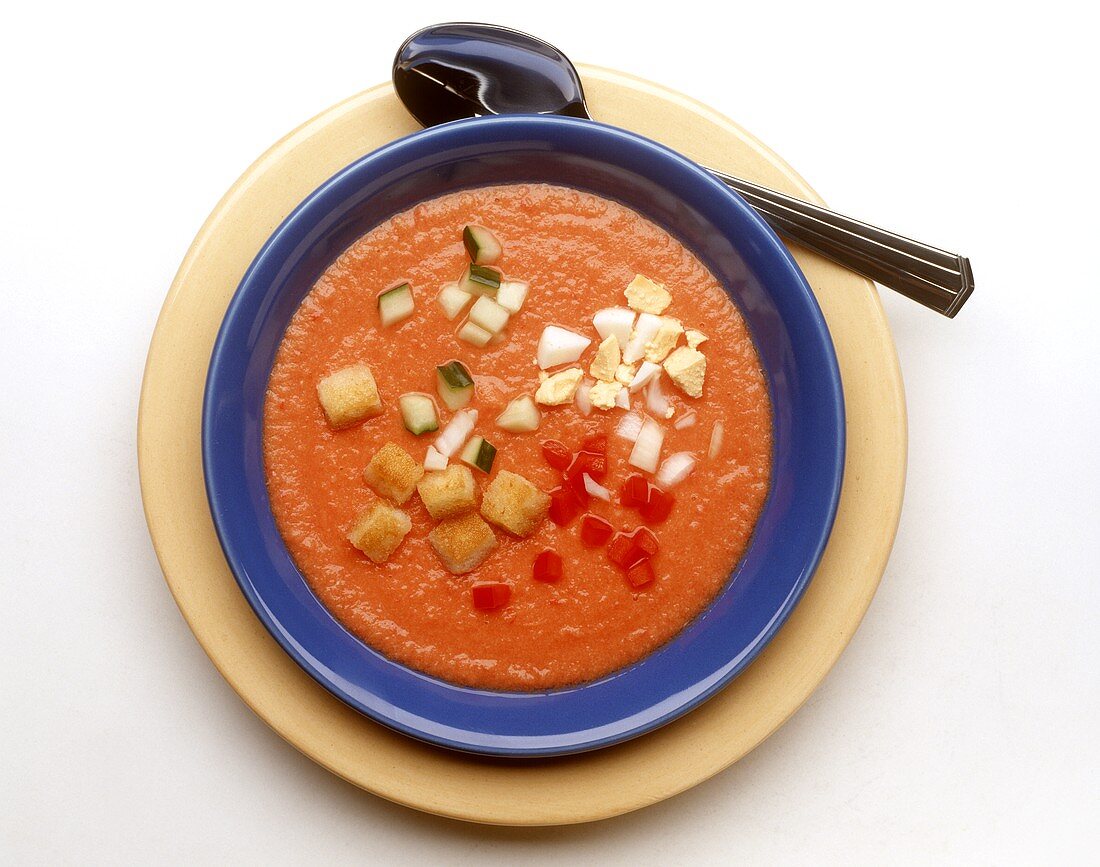 Cold tomato soup with vegetables, egg & bread cubes (gazpacho)