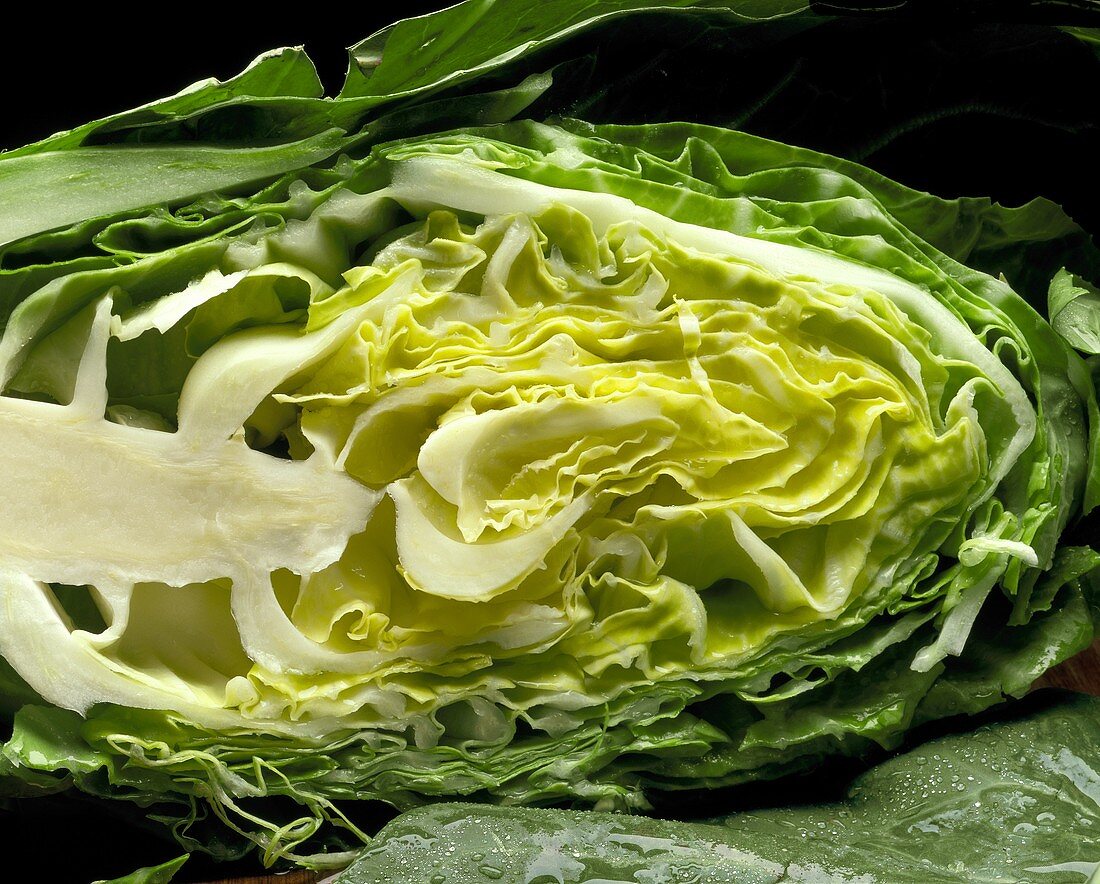 A halved pointed cabbage (cut lengthwise)